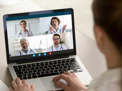 Patient on virtual conference with doctors.